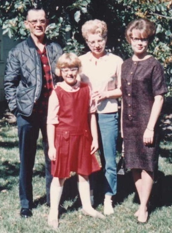 Gramma Grandpa and daughters Anita and Julie outside their Watford City ND Home vertical.jpeg