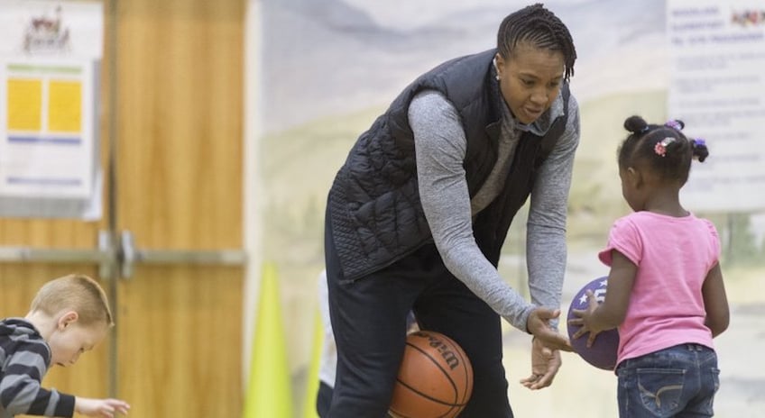 Outspoken Christian, community leader, and retired WNBA superstar Tamika Catchings works with children as part of programming for underprivileged children hosted by her Catch the Stars Foundation, pictured in this Knoxville News Sentinal photo.