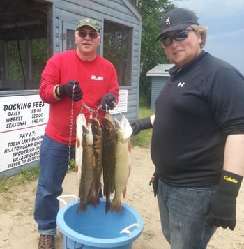 Mike and oldest grandson Ethan display their catch after a day on the water.