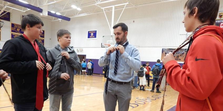 At Bright Futures' Tie Day Assembly at Berryville Middle School in March, every male student was given a tie and was placed in a small group to learn how to tie it; community volunteers led each group, showing them step-by-step how to form their tie knots until each student had it down. The mentors also talked to the young men about topics such as self-confidence and the importance of firm handshakes, making eye contact and showing respect to others.