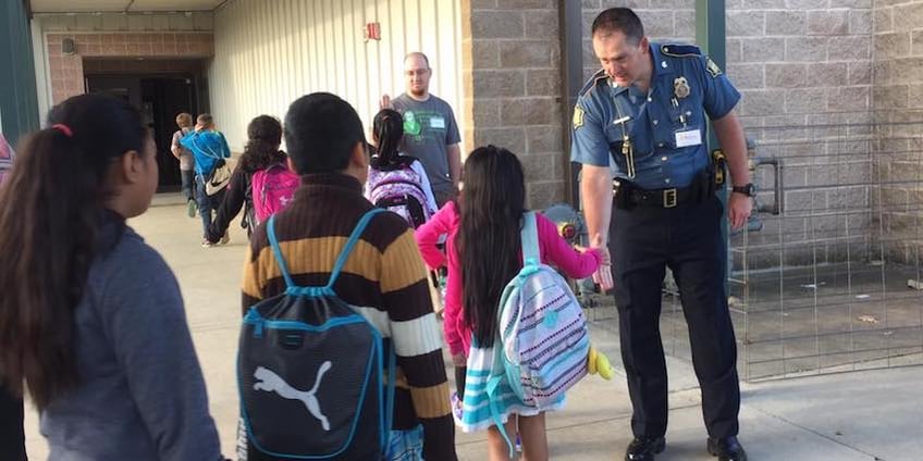 Bright Futures Berryville volunteers Chad Hipps, a local trooper with the Arkansas State Police, and Josh Comer, youth pastor at Freeman Heights Baptist Church, were two of dozens of "Champions" who greeted students every morning during standardized testing in April at Berryville's elementary, intermediate and middle schools.