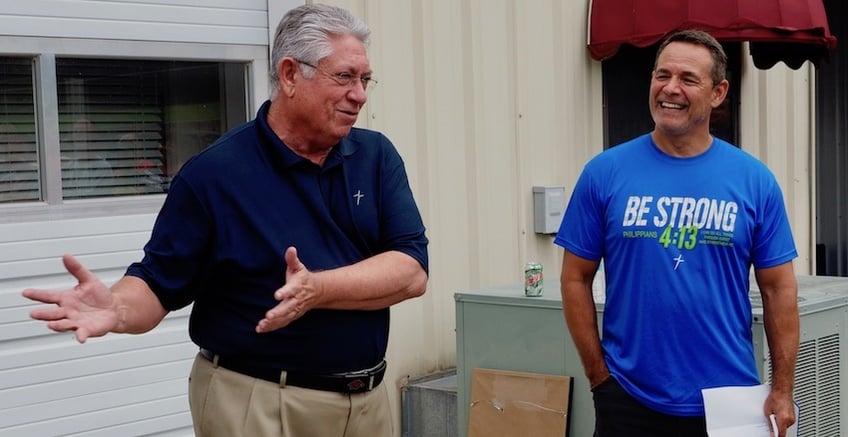 Retiring HR Director Bob Ahart, left, describes his "moment of glory" when, during his 30s, he returned an errant kick during a Dallas Cowboys scrimmage to "make" the extra points, as Founder & CEO Vic Kennett laughs, during Ahart's retirement send-off party recently at Kerusso HQ. Ahart had been enjoying watching the scrimmage from the sidelines, with family who worked for Cowboys owner Jerry Jones.